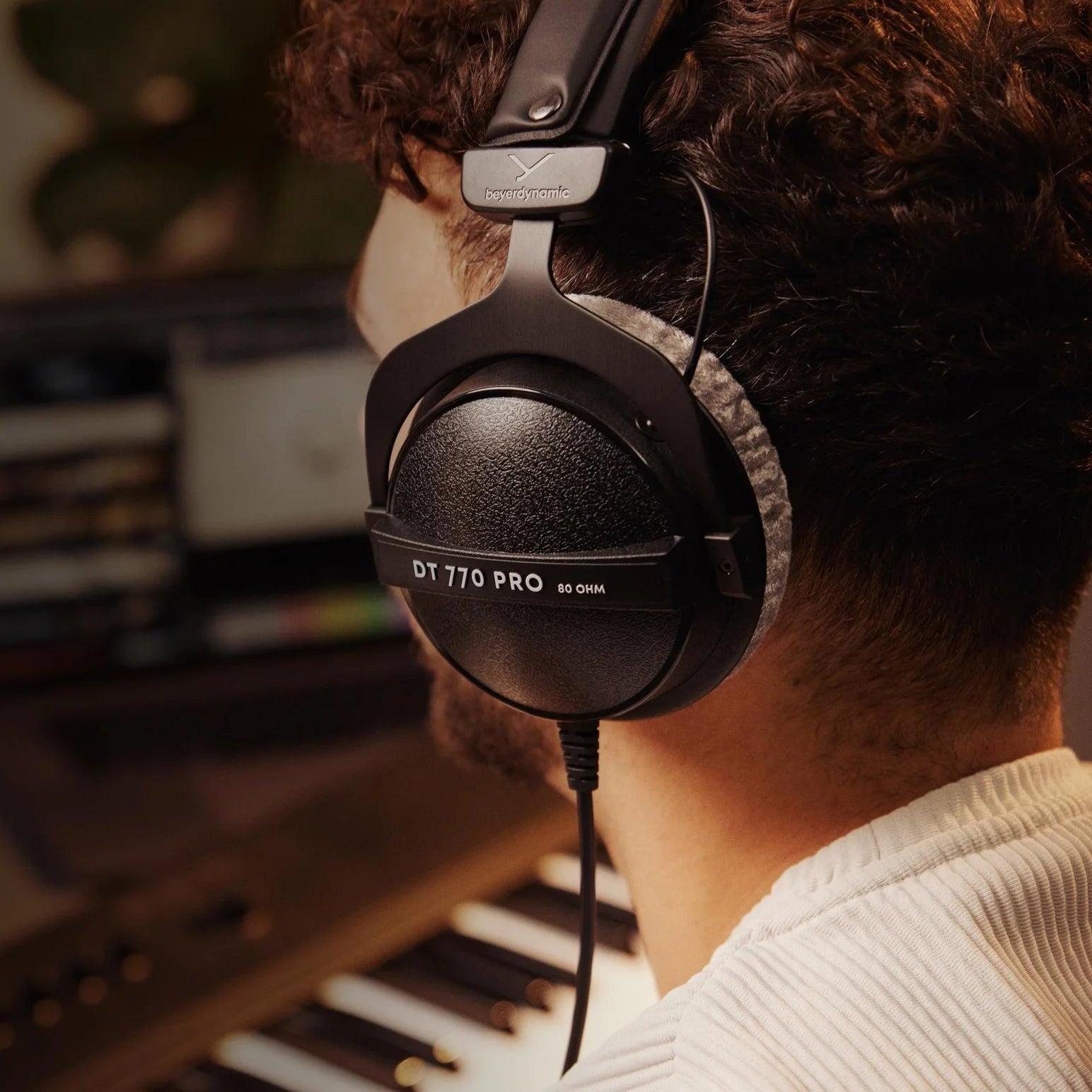 Beyerdynamic DT 770 Pro studio headphones with over-ear design, black color, and coiled cable for professional audio monitoring.