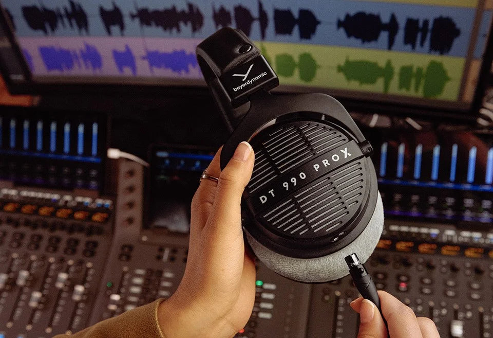 Beyerdynamic DT 990 Pro X studio headphones with over-ear design and coiled cable, black and silver color.