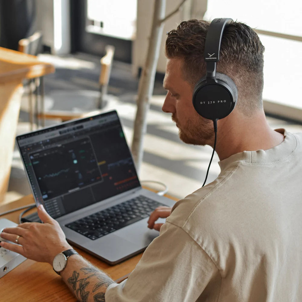 Beyerdynamic DT 270 Pro studio headphones with over-ear design and black finish, displayed on a laptop with USB-C connection.