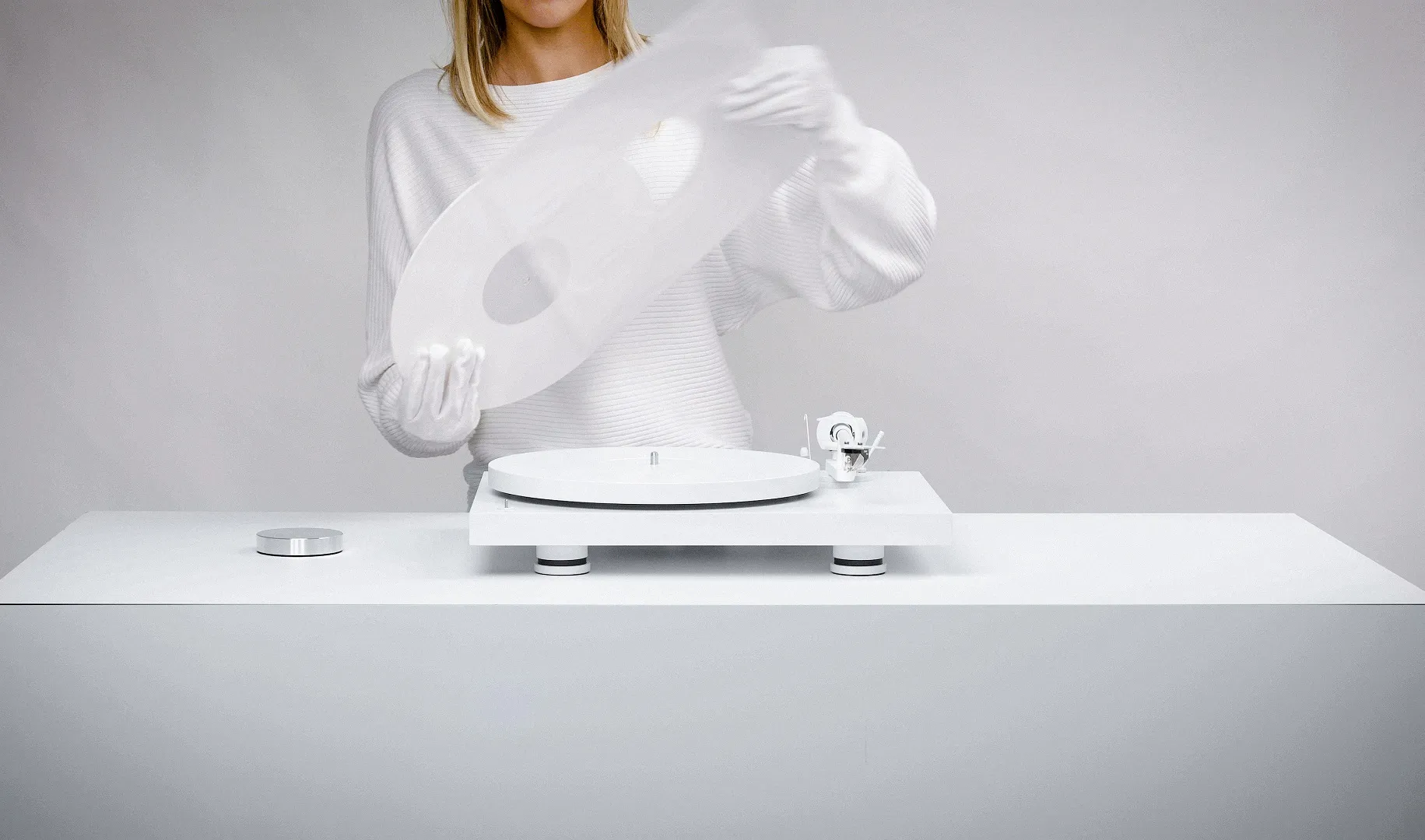 Pro-Ject Debut Pro white edition turntable with sleek design and tonearm, featuring high-quality audio components and modern aesthetics.