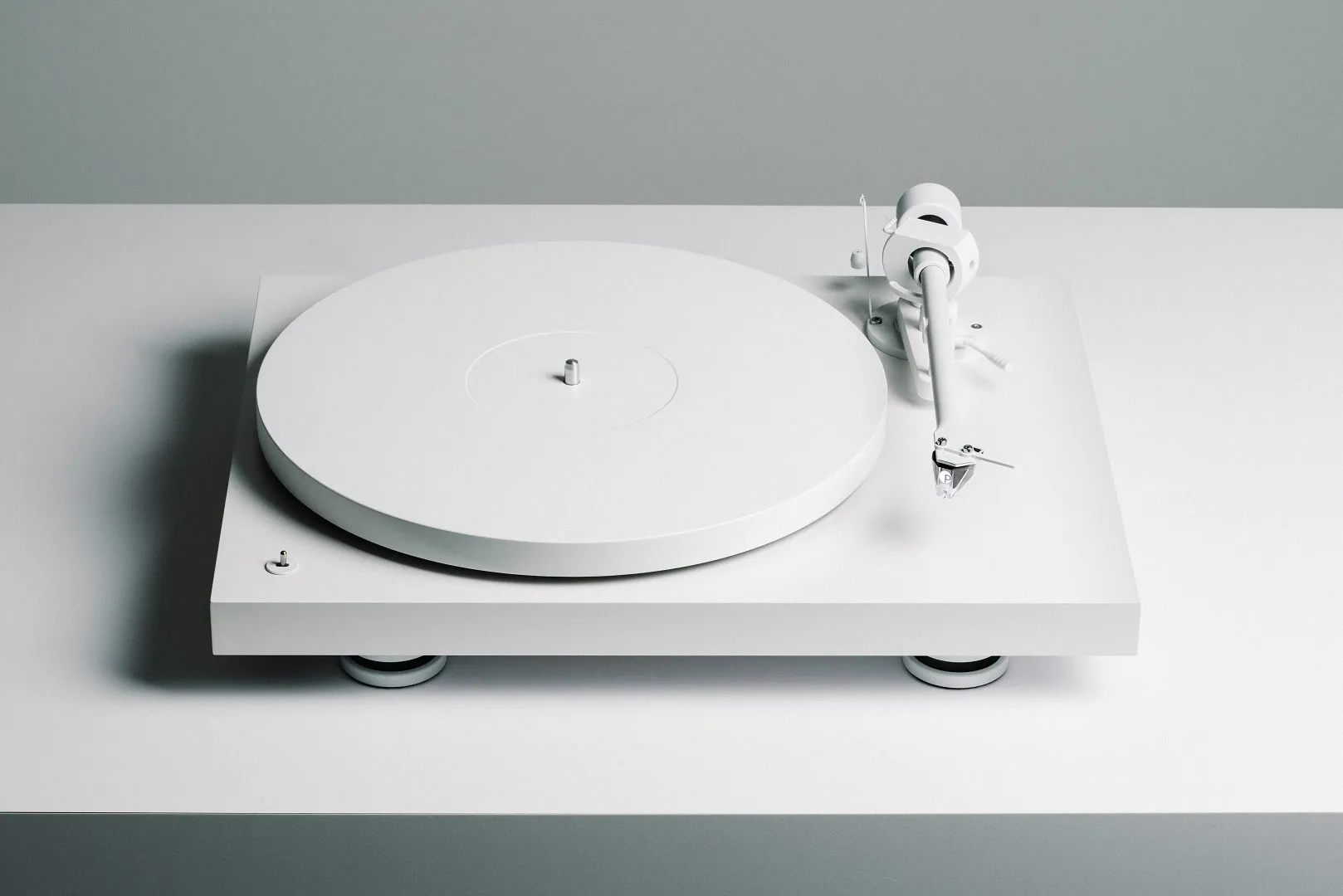 Pro-Ject Debut Pro white edition turntable with sleek design and tonearm, featuring high-quality audio components.