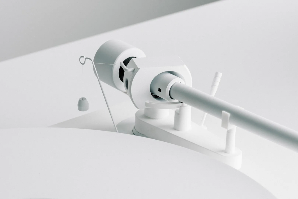 Pro-Ject Debut Pro white edition turntable with sleek design and tonearm, showcasing high-quality audio equipment.
