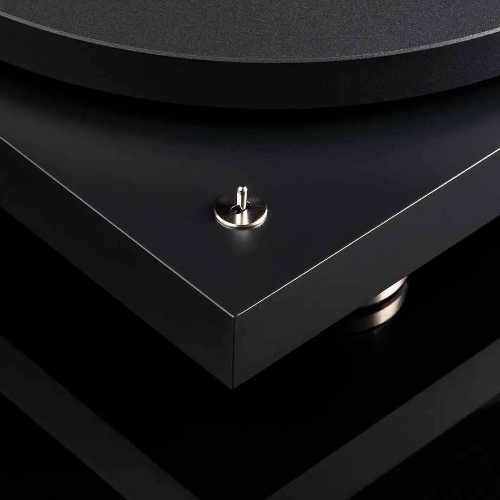 Pro-Ject Debut Pro turntable with sleek design, featuring a tonearm and platter, set in a modern listening environment.