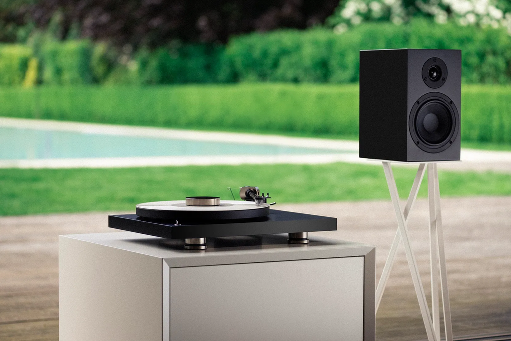 Pro-Ject Debut Pro turntable in a stylish living room setting, showcasing its sleek design and premium build quality.