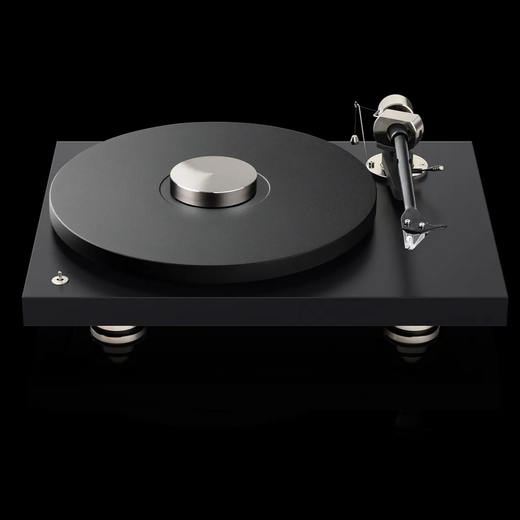 Pro-Ject Debut Pro turntable with sleek design, close-up of tonearm and platter, set in a stylish listening room environment.