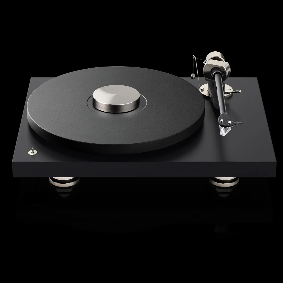 Pro-Ject Debut Pro turntable with sleek design, close-up of tonearm and platter, set in a stylish listening room environment.