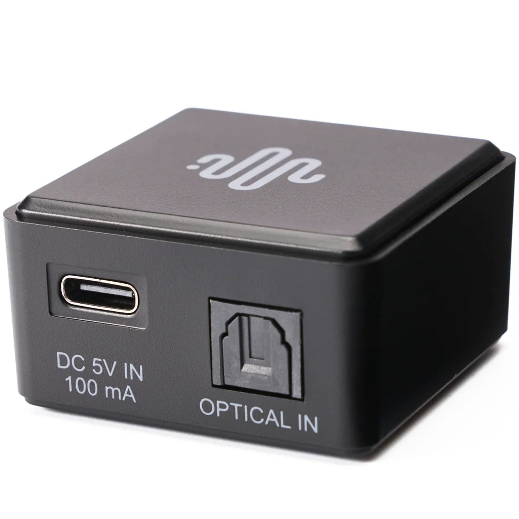 Essentials NanoDac headphone amplifier and DAC in black, compact design with controls and input ports visible.