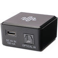 Essentials NanoDac headphone amplifier and DAC in black, compact design with controls and input ports visible.