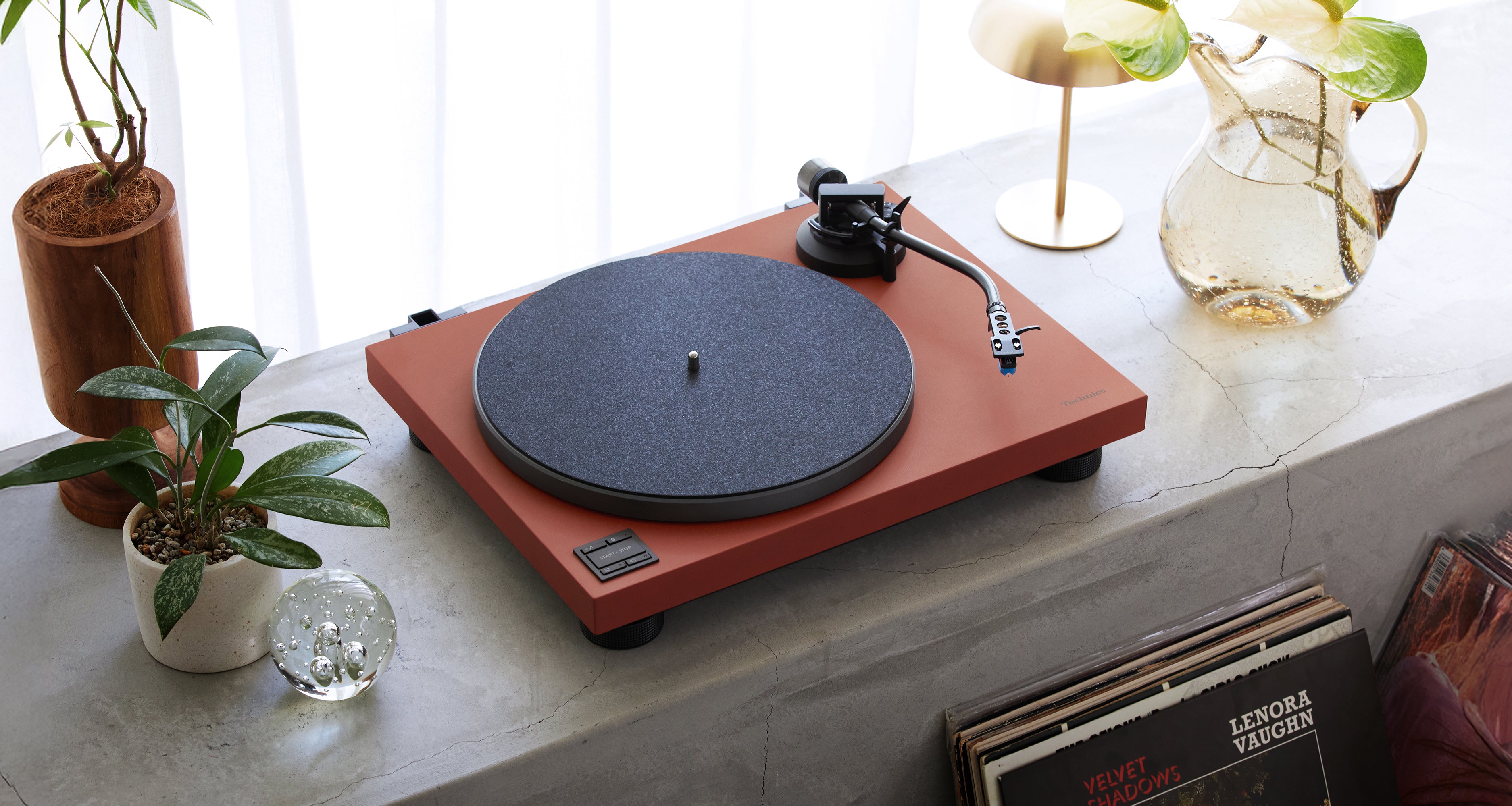 Technics SL-40CBT turntable with a sleek design, featuring a tonearm and record platter for high-quality vinyl playback.