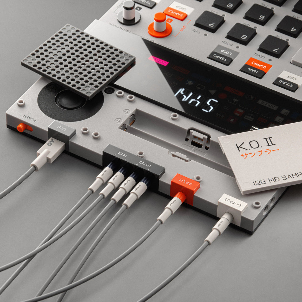 Teenage Engineering EP-133 K.O. II drum machine and sampler with colorful interface and connectivity ports on a sleek black device.
