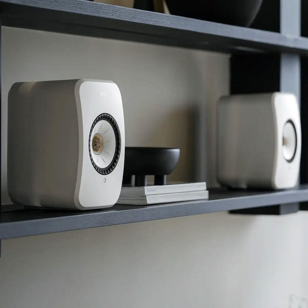 KEF LSX II wireless active bookshelf speakers with sleek black finish and modern design, showcasing compact size and front-facing drivers.