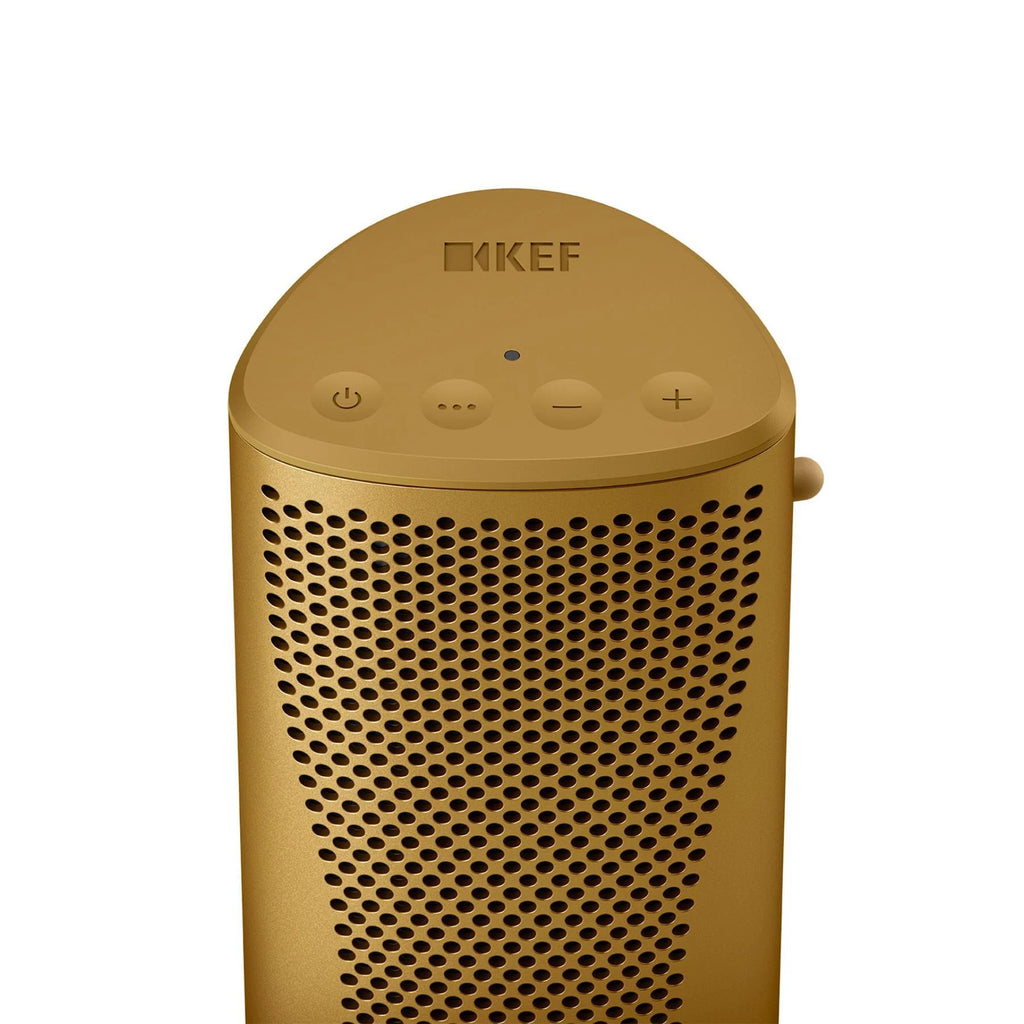 KEF Muo portable speaker in amber haze color with a sleek top view, showcasing its compact and modern design.