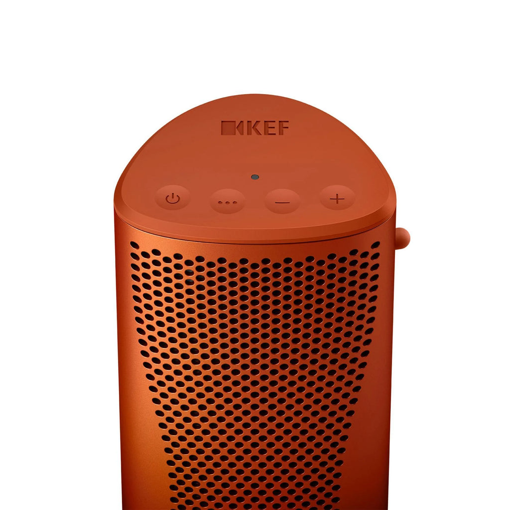 KEF Muo portable speaker in orange with moon-inspired top controls and sleek design, showcasing its compact and stylish appearance.