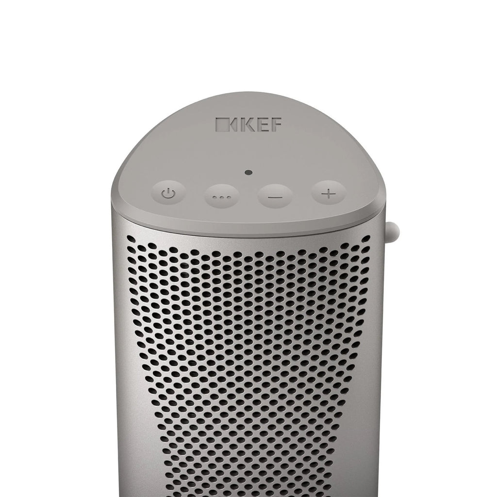 Silver KEF Muo portable speaker with top controls and sleek design, showcasing its compact, modern look.