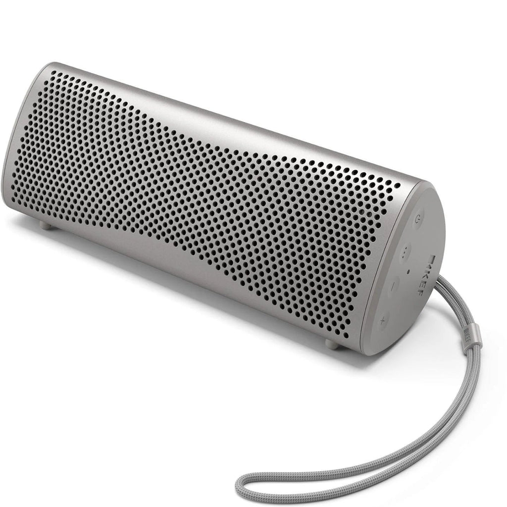 Silver KEF Muo portable speaker with a sleek cylindrical design and textured surface, ideal for high-quality music on the go.