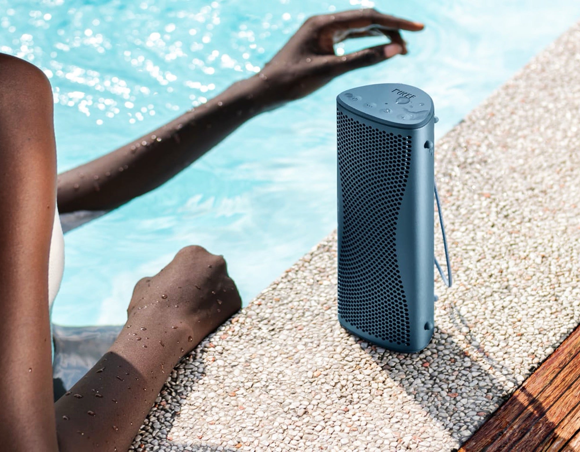 KEF Muo portable speaker with sleek black design, compact size, and control buttons on top, showcasing modern audio technology.