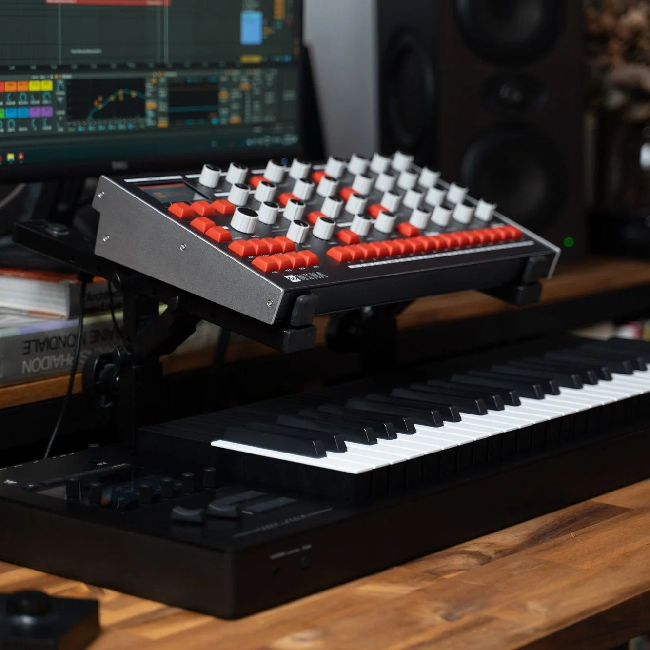 Melbourne Instruments Nina semi-modular synthesizer with patch cables and control knobs, showcasing its compact design and interface.