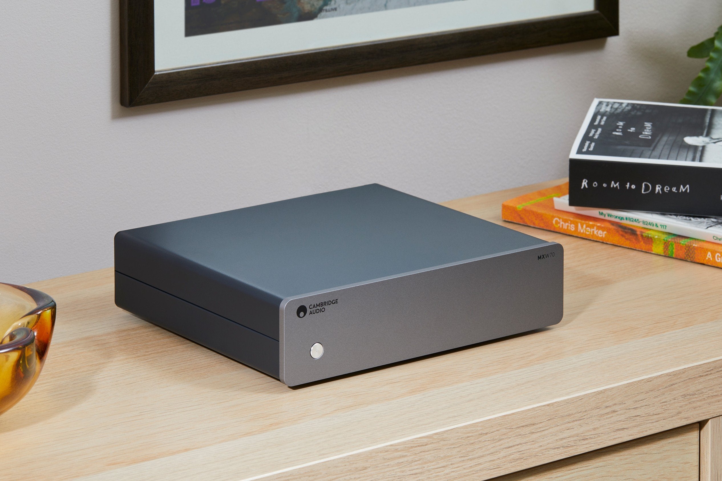 Cambridge Audio MXW70 stereo amplifier with sleek black finish and control knobs, designed for high-quality audio performance.