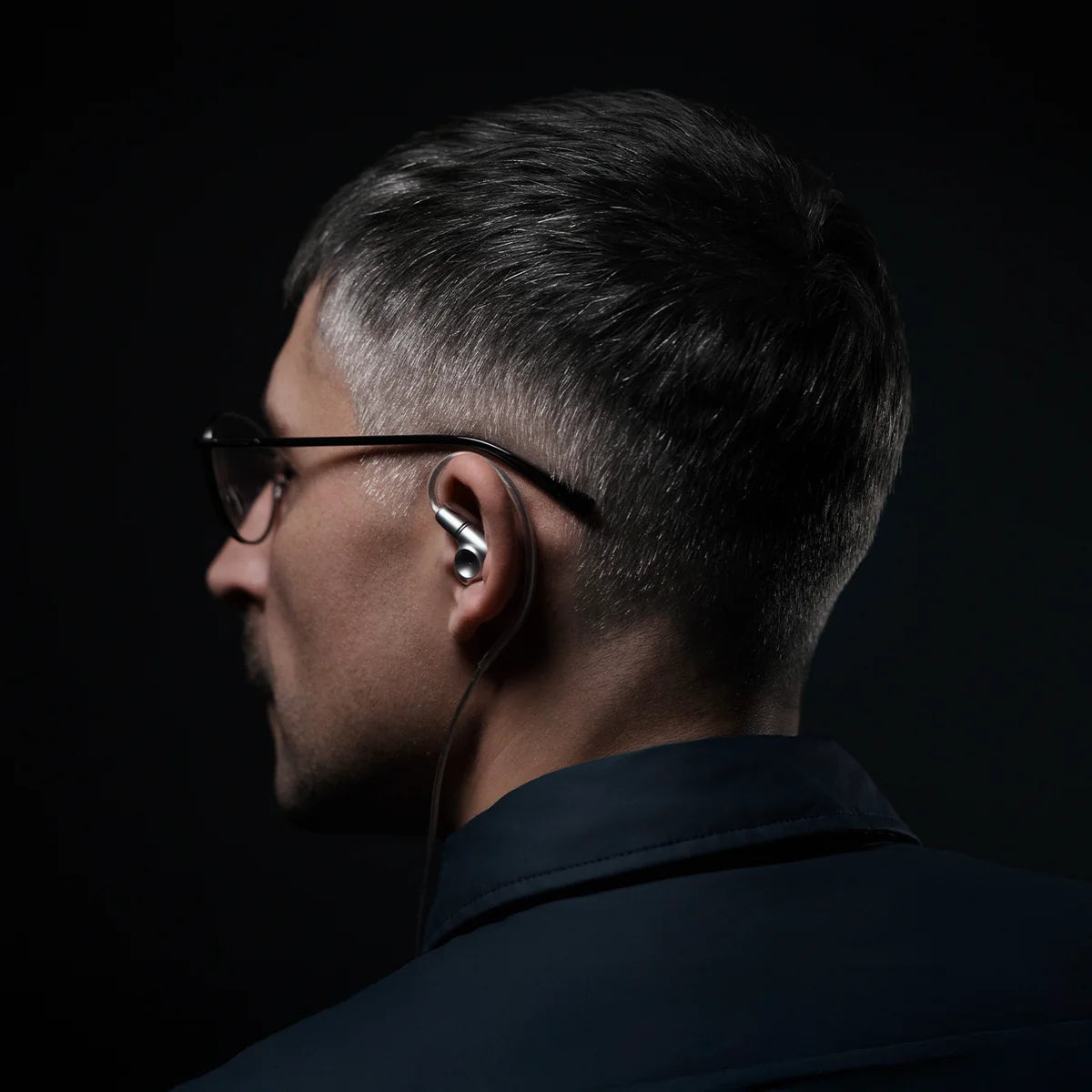 Meze Audio Astru wired in-ear headphones with black earbuds and inline remote on a white background.