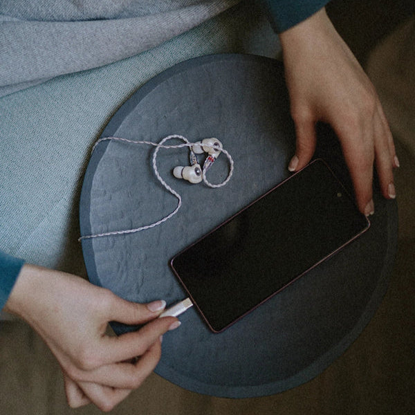 Meze Audio Alba in-ear headphones with black ear tips and sleek design, shown from a front angle.