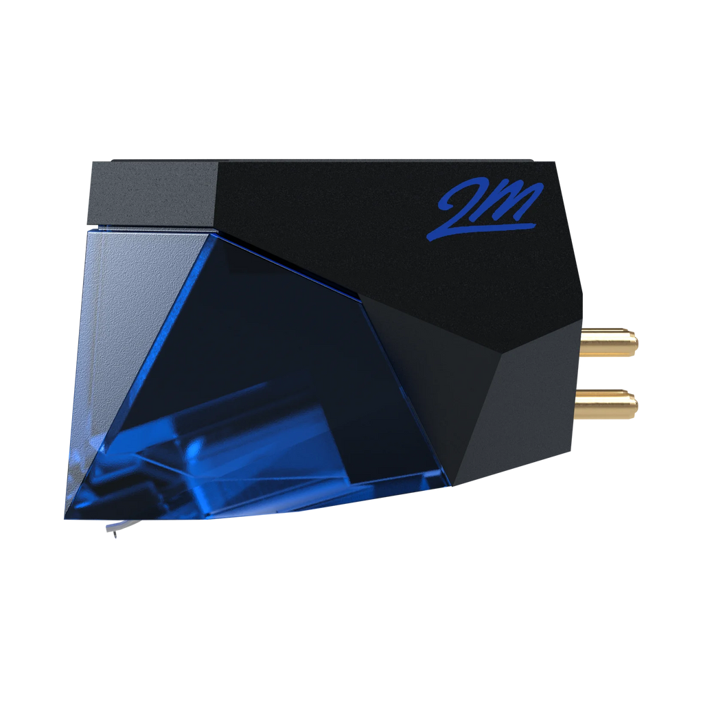 Ortofon 2M Blue turntable stylus cartridge shown from the left side, featuring the blue stylus and cartridge body.