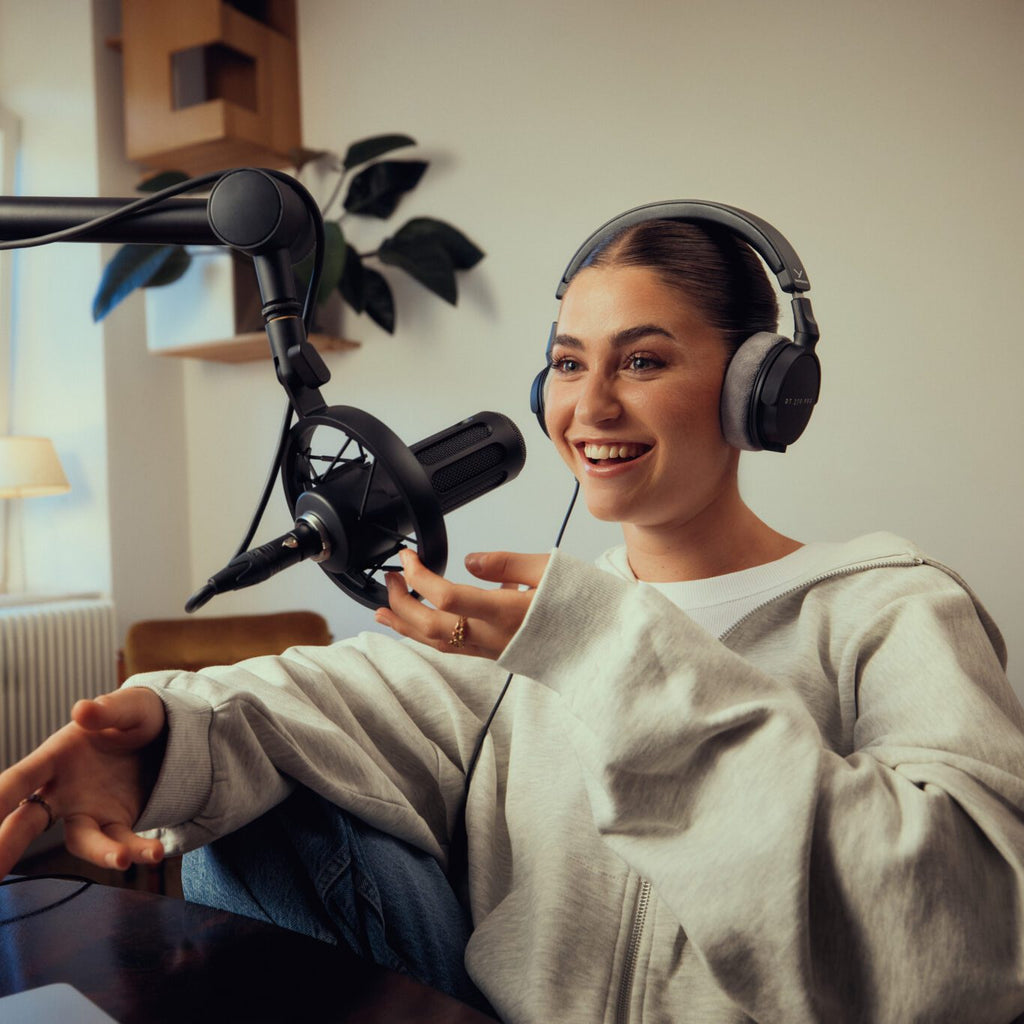 Beyerdynamic DT 270 Pro studio headphones worn by a girl recording a podcast in a home studio setting.