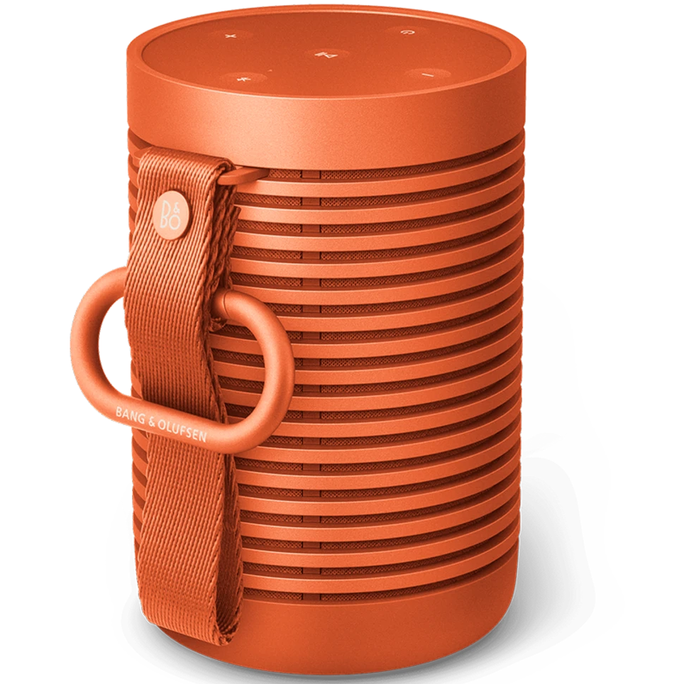 Bang & Olufsen Beosound Explore portable speaker in Bonfire Orange, showing the compact, rugged design and textured surface.