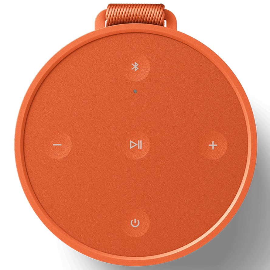 Bang & Olufsen Beosound Explore portable speaker in Bonfire Orange, showing the compact, rugged design and textured exterior.