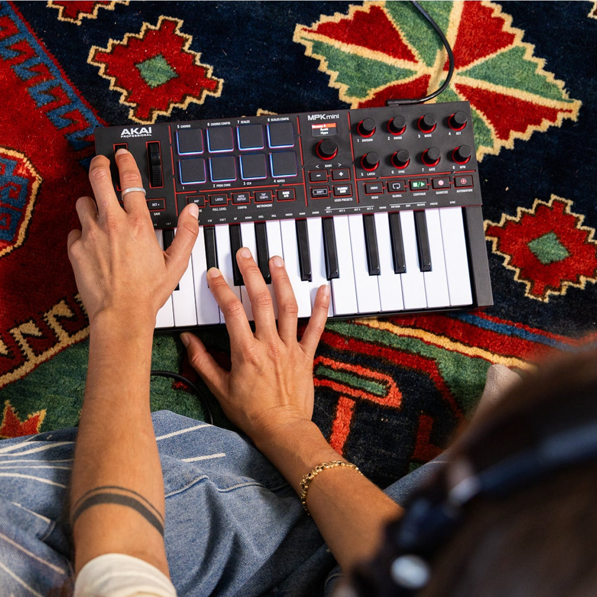 Akai Professional MPK Mini IV MIDI keyboard controller with compact design, 25 keys, and control pads.