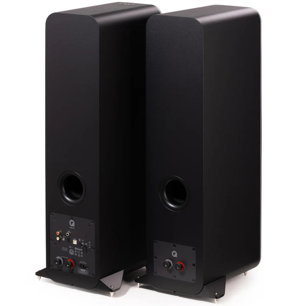 Pair of black Q Acoustics M40 wireless speakers shown from the rear at an angle, highlighting the speaker design and ports.