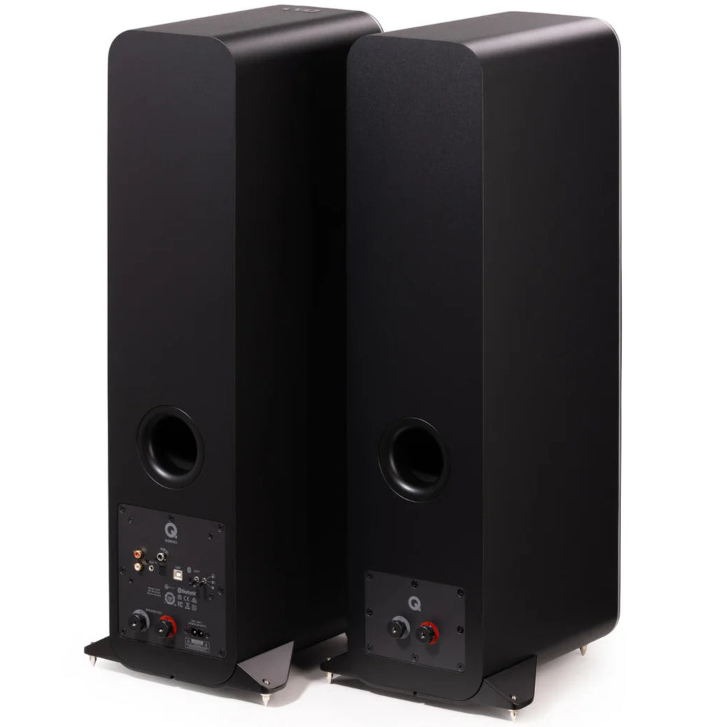 Pair of black Q Acoustics M40 wireless speakers shown from the rear at an angle, highlighting the speaker design and ports.
