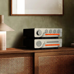 Quad 3CDT CD player sitting on a modern media stand, featuring a sleek black design and multiple disc trays, for high-quality audio playback.