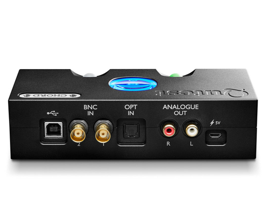Chord Electronics Qutest DAC and headphone amplifier with rear connections, compact black device on a wooden surface.