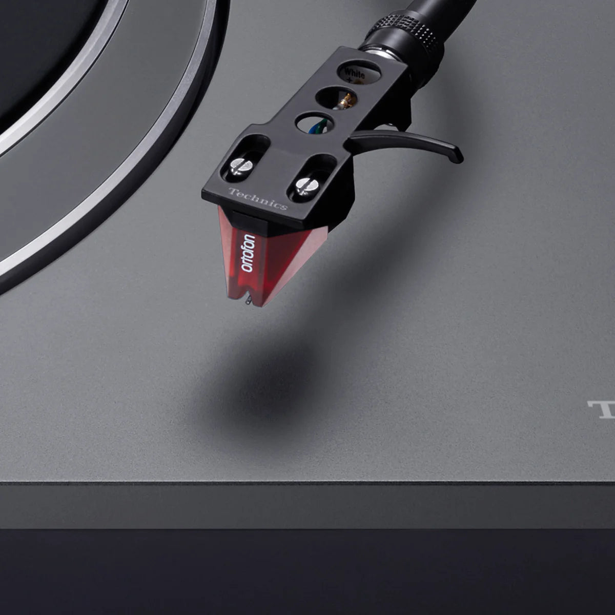 Technics SL-1500CS turntable with a close-up of the tonearm and cartridge, showcasing its sleek design and high-quality audio components.