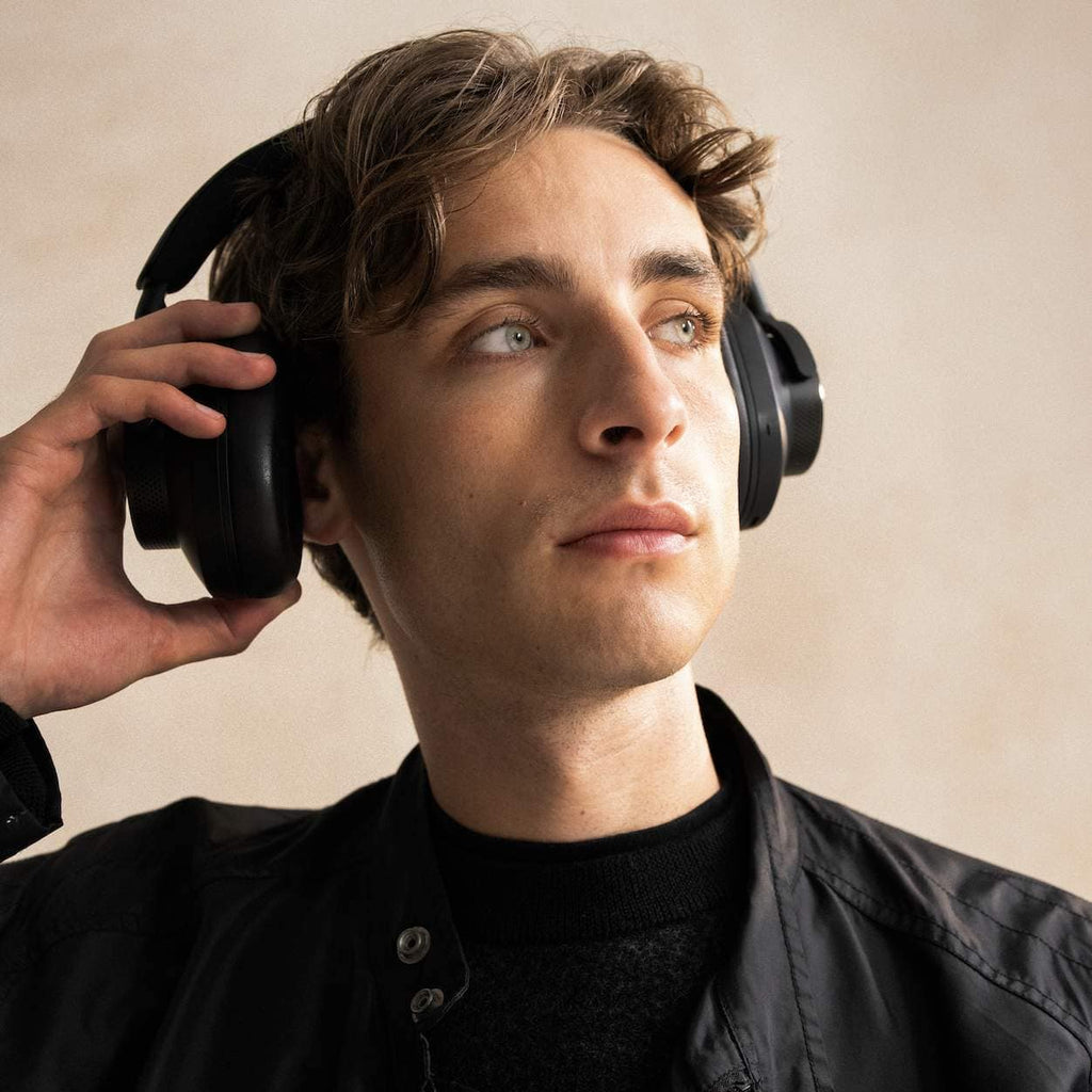 Cambridge Audio Melomania P100 SE wireless headphones with sleek design and in-ear earbuds, displayed on a white background.