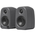 Kanto Audio UKI desktop speakers with sleek black finish and front speaker grille, designed for high-quality audio on a desk.