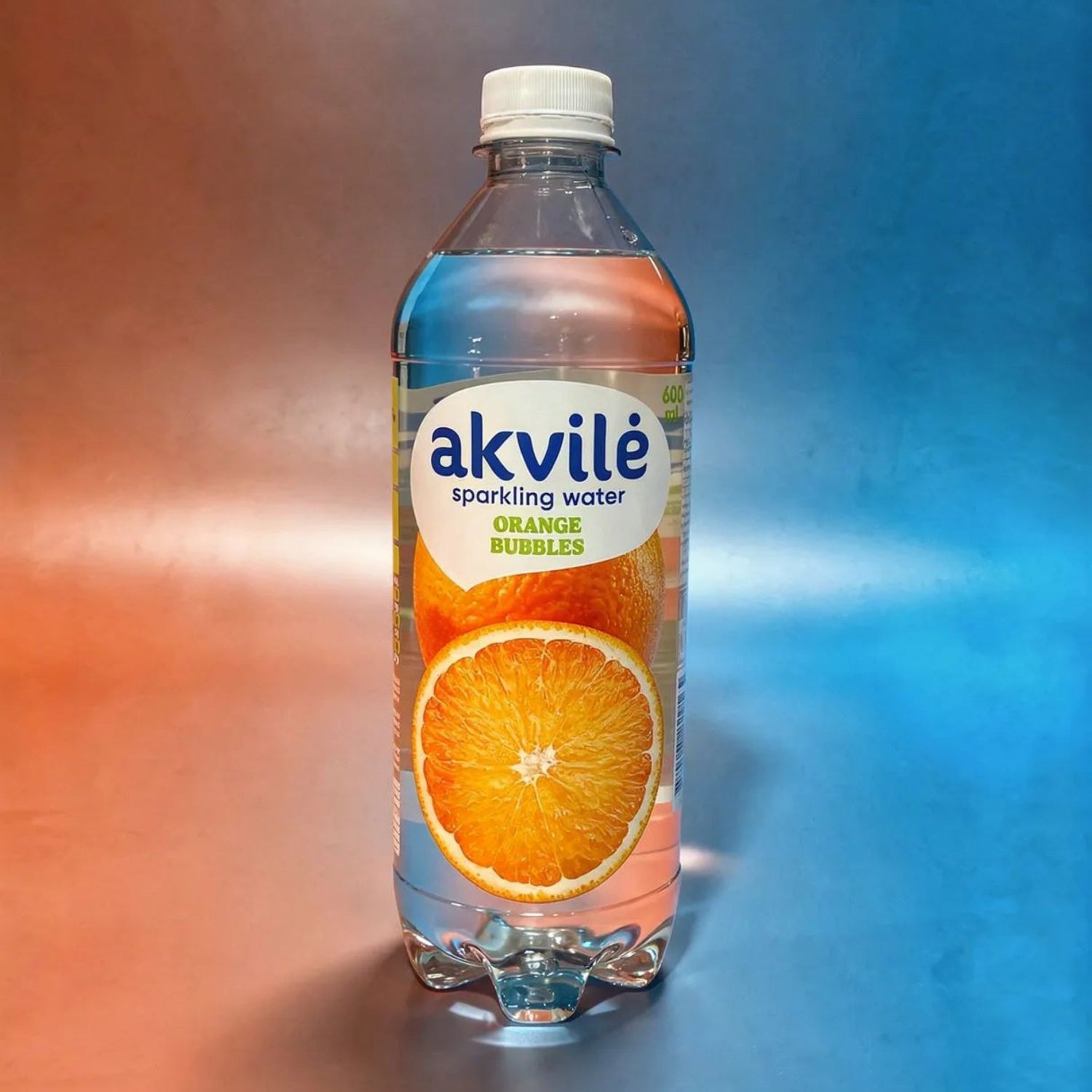 Akvilė orange lightly sparkling water in a 600ml bottle with a vibrant orange label and clear liquid inside.