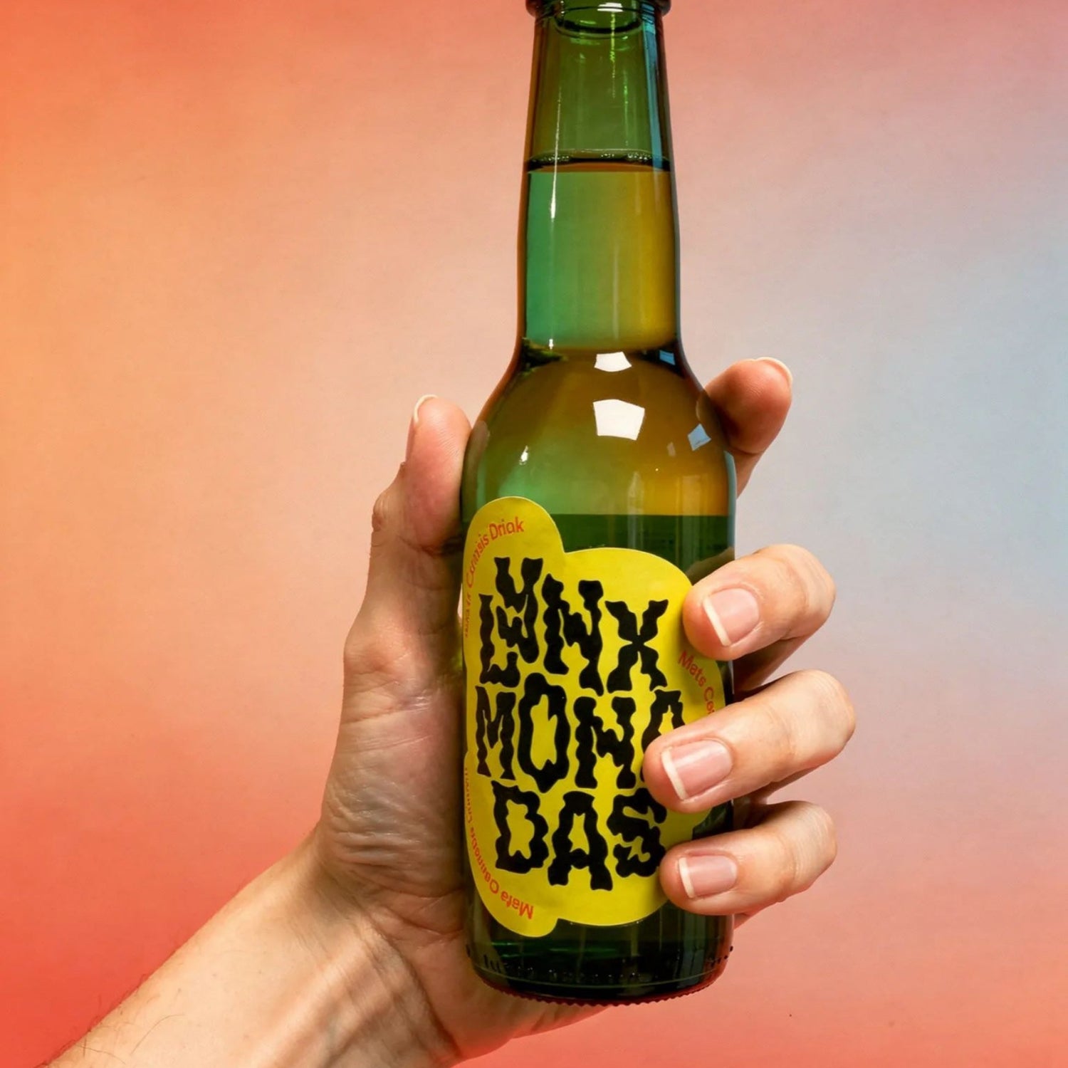 Hand holding a green bottle with a yellow label against a gradient background