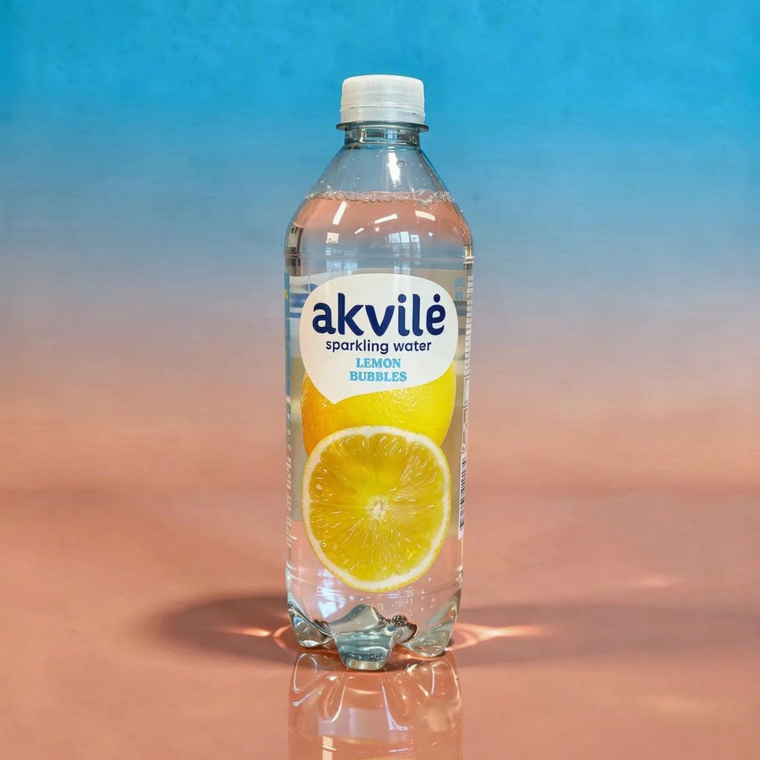 Akvilė Lemon lightly sparkling water in a 600ml bottle, clear with a lemon flavor and bubbles, on a plain background.