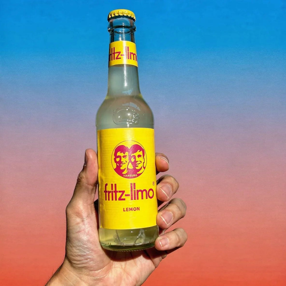 Illustration of Fritz-Limo Lemon unfiltered sour lemonade in a 330ml bottle, showcasing a fresh lemon and vibrant citrus design.