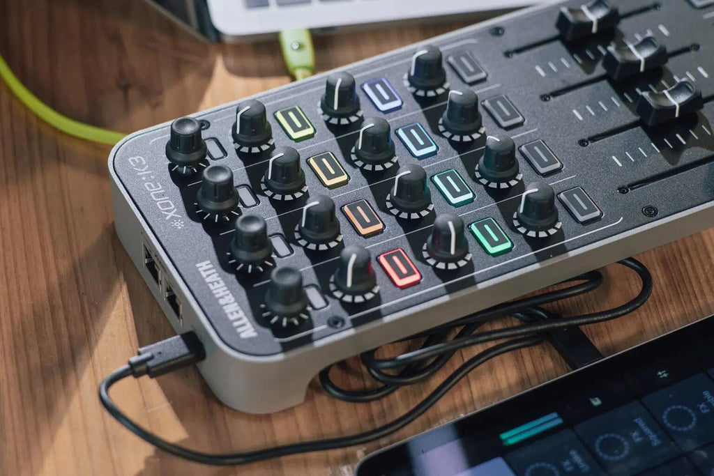 Allen & Heath Xone:K3 DJ controller with multiple knobs, faders, and performance pads for professional DJ mixing and control.