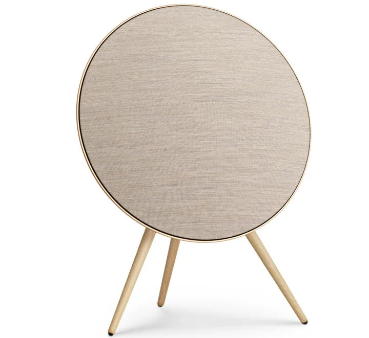 Gold Bang & Olufsen Beosound A9 5th Gen wireless speaker with a sleek, circular design and fabric-covered exterior.