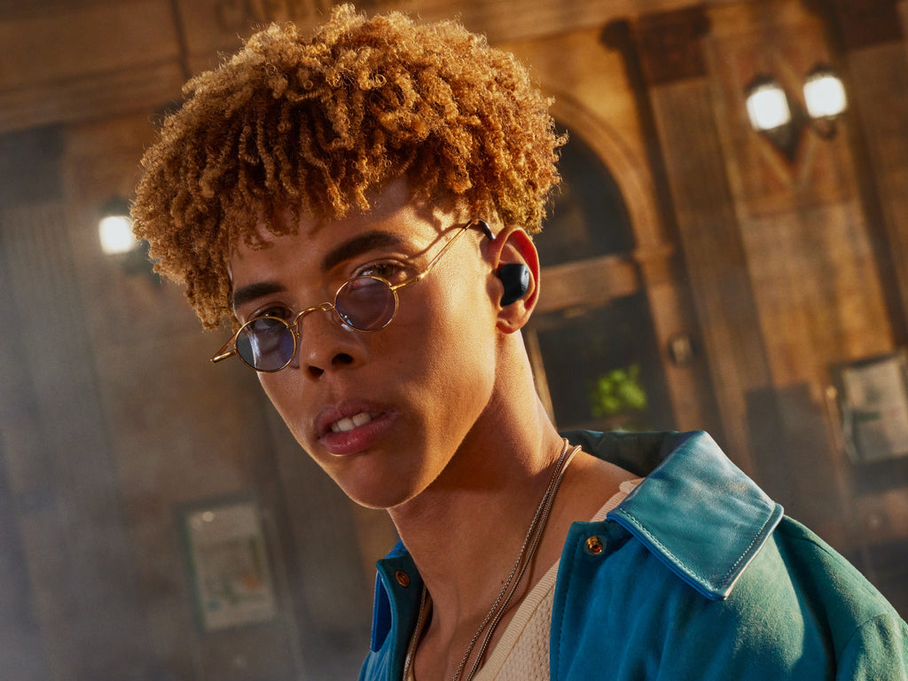 Sennheiser Accentum True Wireless in-ear headphones in black worn by a man, showcasing their sleek design and portable style.