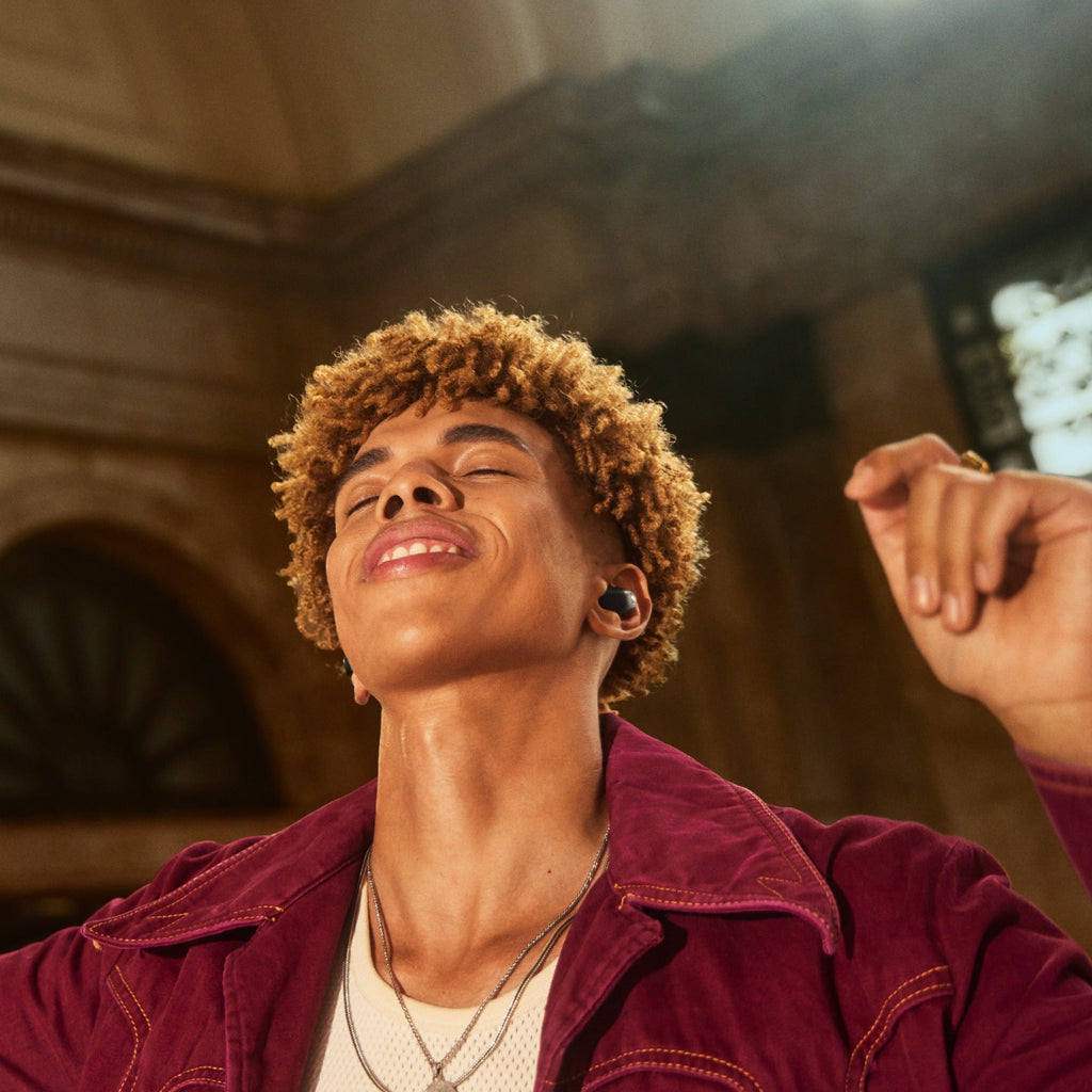 Sennheiser Accentum True Wireless in-ear headphones with sleek design, worn by a man in a lifestyle setting.