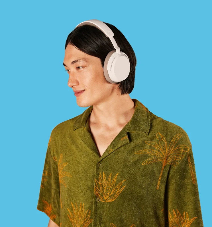 Sennheiser Accentum Wireless headphones worn by a man, showcasing sleek design and over-ear comfort in a white background image.