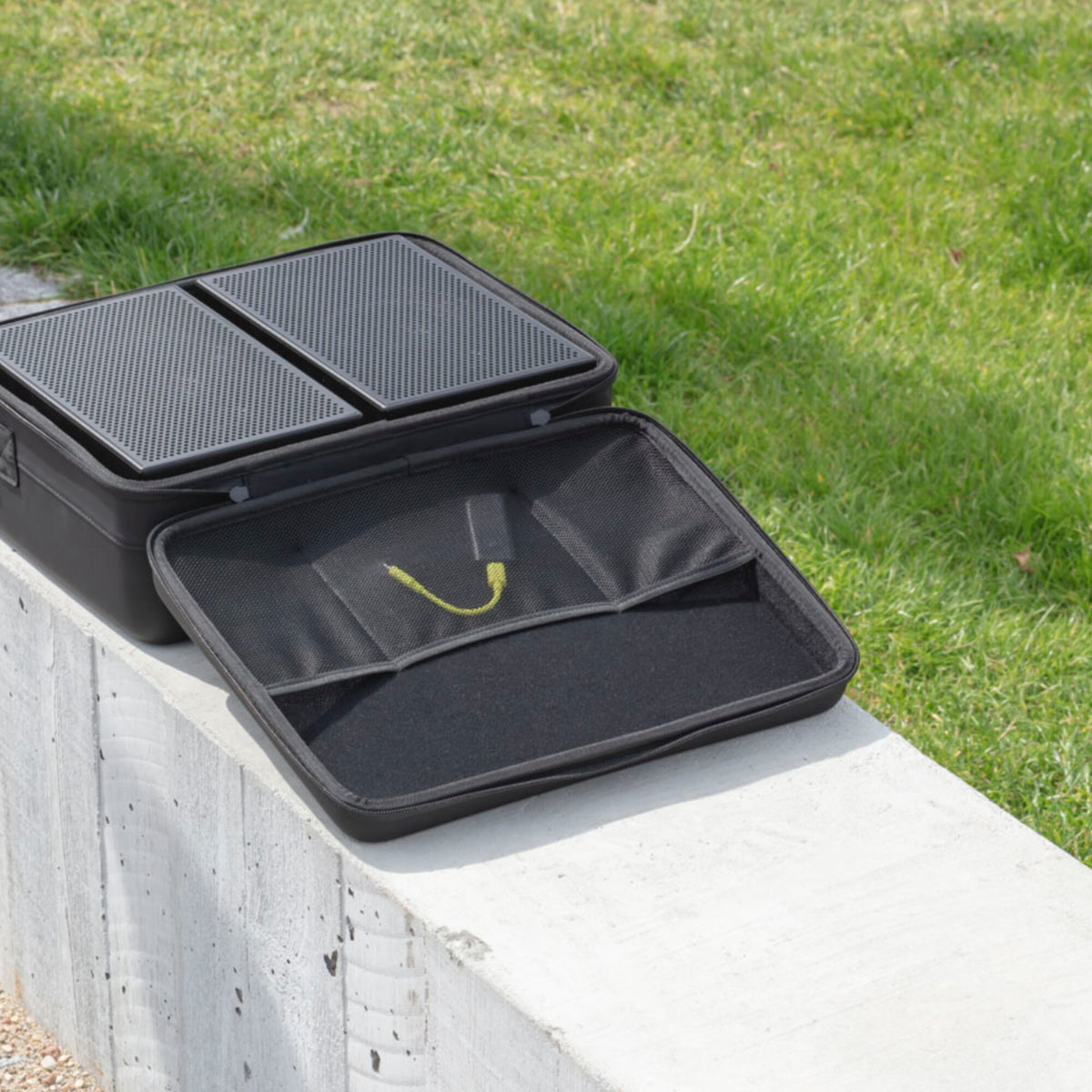 AIAIAI UNIT-4 MKII, both speakers packed in the open carrying case outdoors