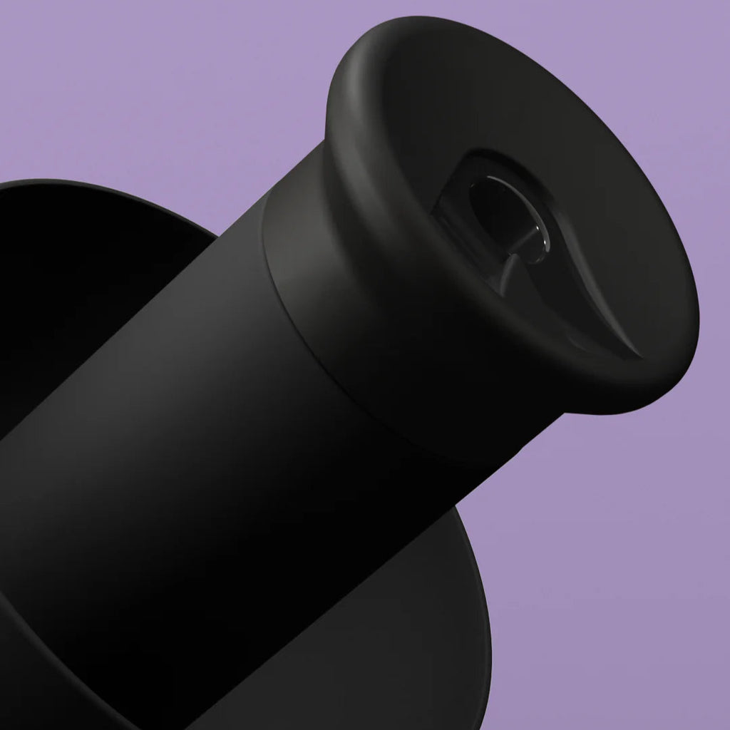 Black Alpine PartyPlug earplugs for hearing protection, shown in close-up with a sleek design and soft silicone tips.