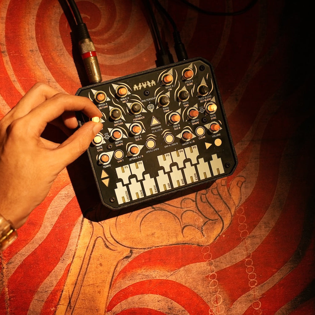 Animal Factory Amplification Asura, hand adjusting a knob in a studio setup