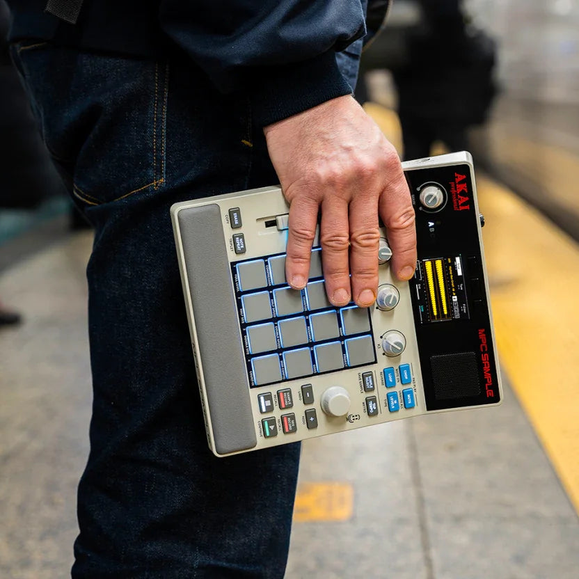 Akai Professional MPC Sample drum machine and sampler with colorful pads and control knobs, designed for music production.