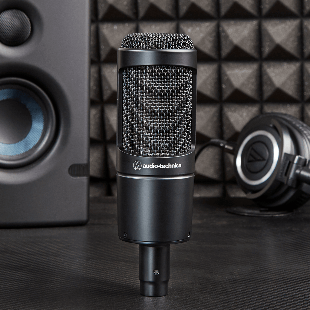 Audio Technica AT 2035 condenser microphone mounted on a stand with a pop filter, ready for studio recording or vocals.